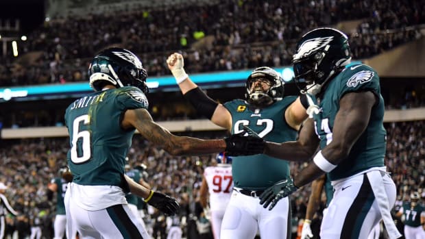 Jason Kelce celebrates with receivers DeVonta Smith and A.J. Brown
